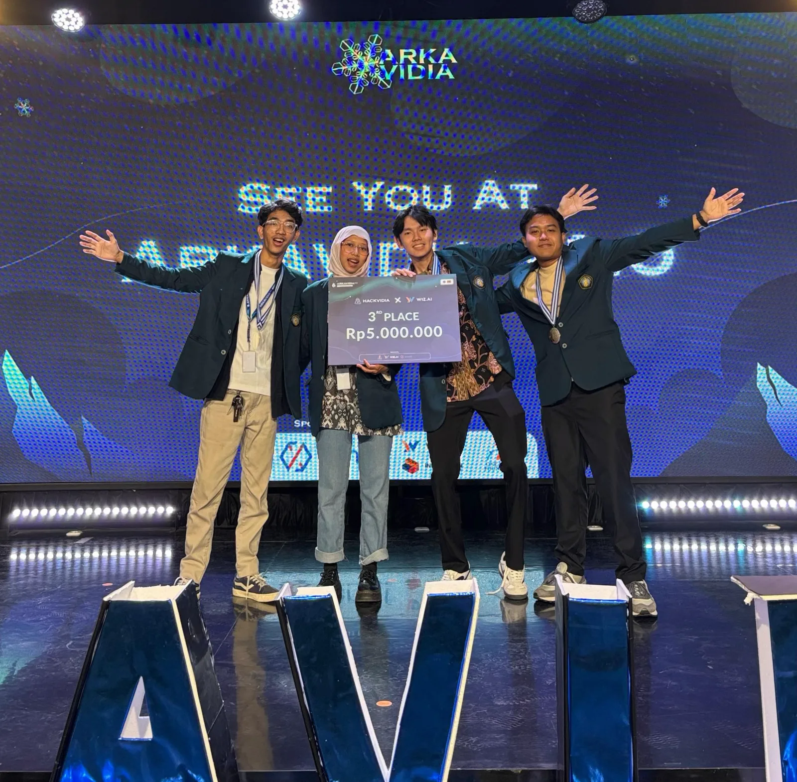 me and my team celebrating third place at Hackvidia Arkavidia ITB