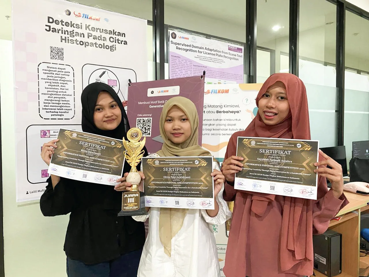 me and my teammates holding certificates and a trophy for a UI/UX competition that we won third place for!