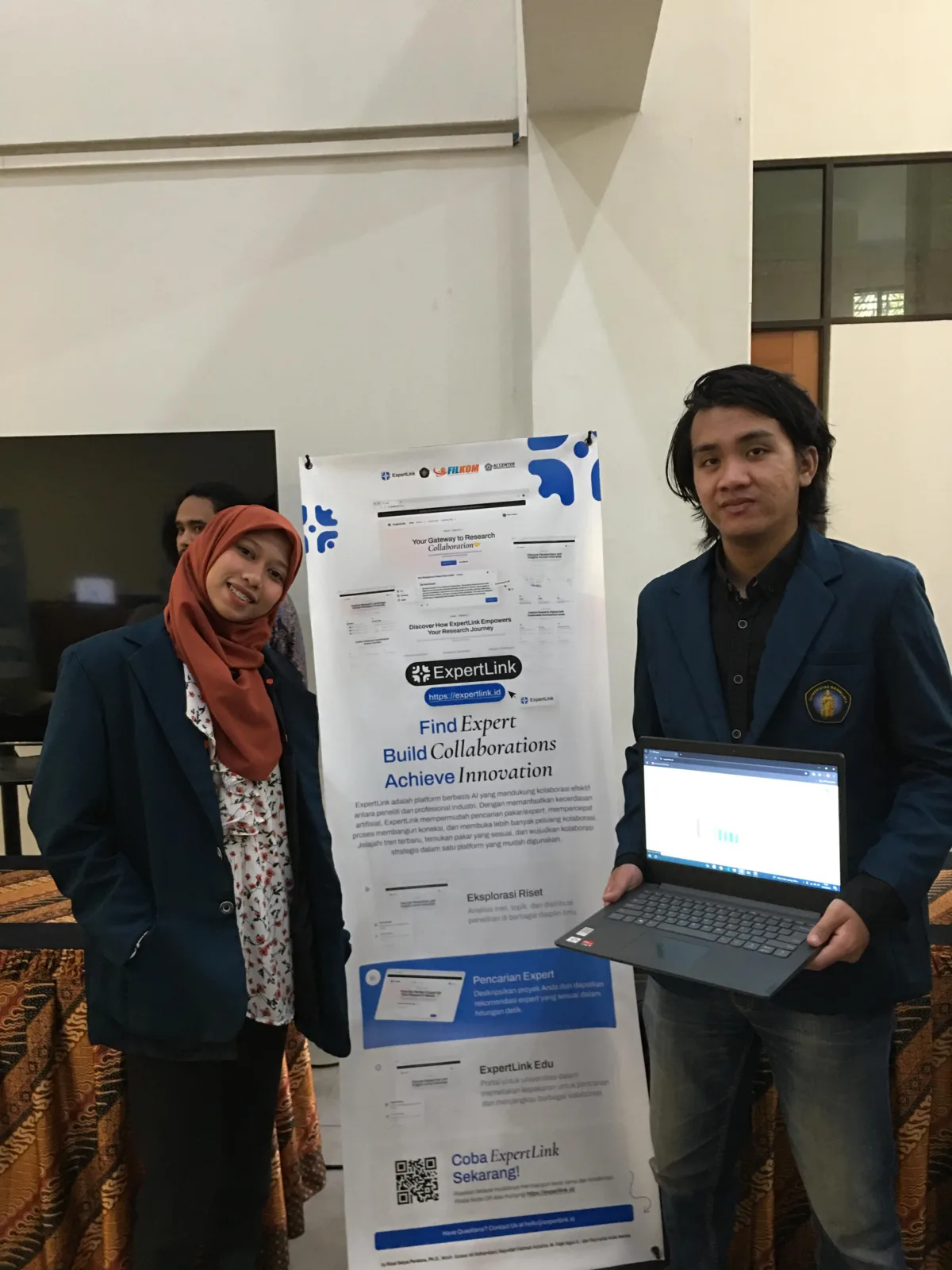me presenting the ExpertLink research collaboration platform banner with my teammate