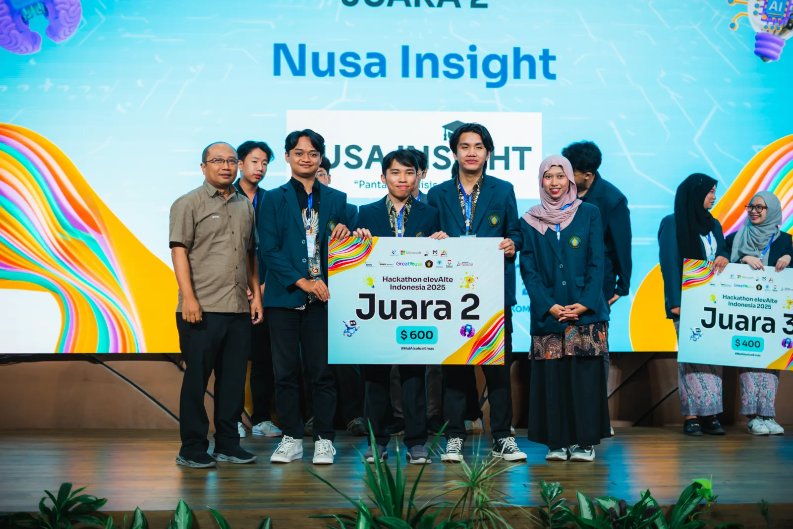 me and the Nusa Insight team receiving second place on stage